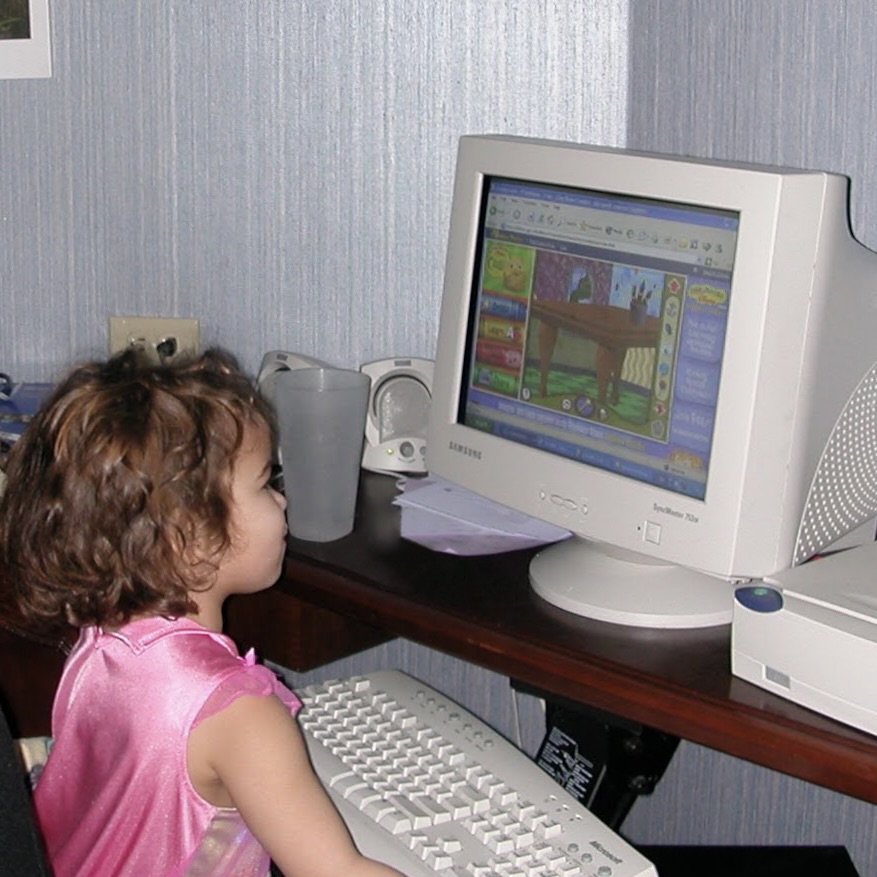 Young Gabby playing a video game on an old computer